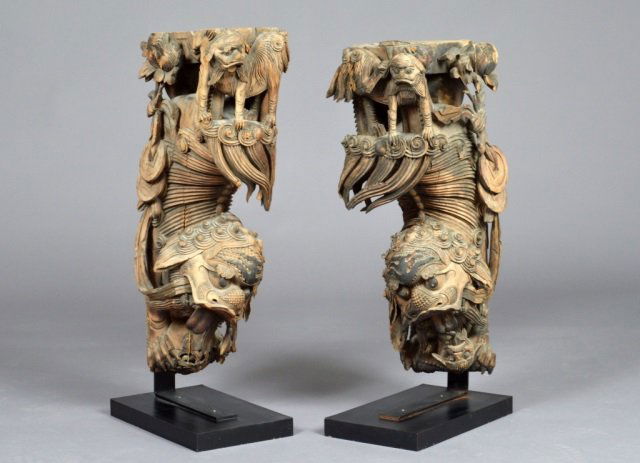 Pair of Oriental Wood Carved Brackets: Each, depicting foo dogs and dragon, mounted on bases. Height 34 inches, width 9 inches, depth 15 inches.