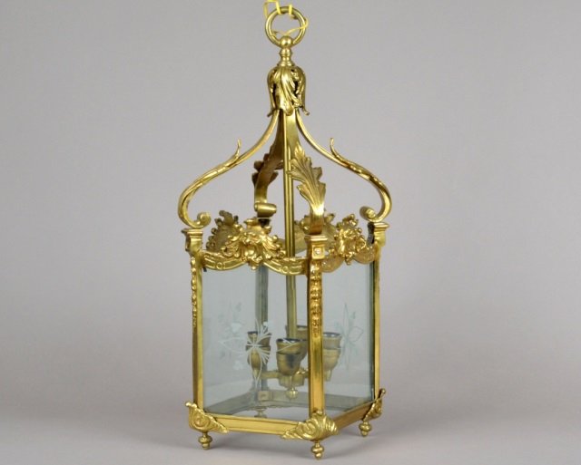 Brass & Glass Four Light Lantern: With etched glass panels, lion's head motif. Height 28 inches, width 10 inches, depth 10 inches.