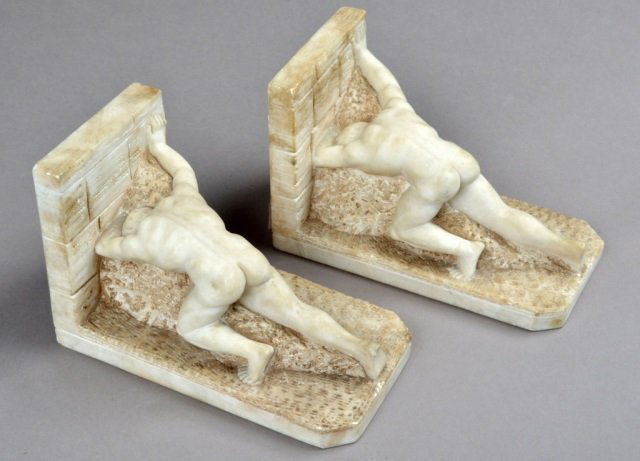 Pair of Alabaster Bookends: Neoclassical style with nude male figural motif. Height 5 inches.