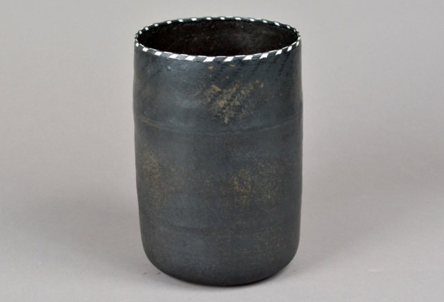 Jane Reumert (Danish, 1942) Earthenware Vessel: Black earthenware with checkered rim. Inscribed on bottom. Height 11 inches, diameter 7 1/2 inches.