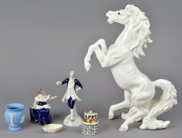 Group of Six Assorted Porcelain Table Articles: Comprising two Royal Dux figurines; a rampant colt figure; Wedgwood vase; Fornasetti calendar; Belleek nut dish. Rampant colt height 20 inches.