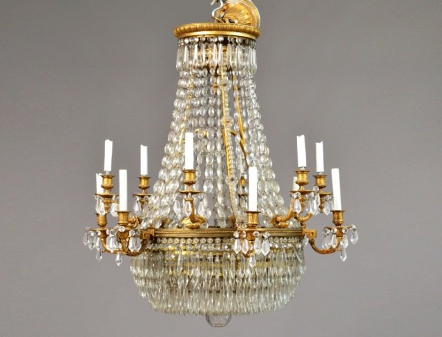 Louis XVI Style Gilded Bronze Two Tier Chandelier: Twelve lights with lozenger rosettes and descending 4 inch drops. Height 32 inches, diameter 30 inches.
