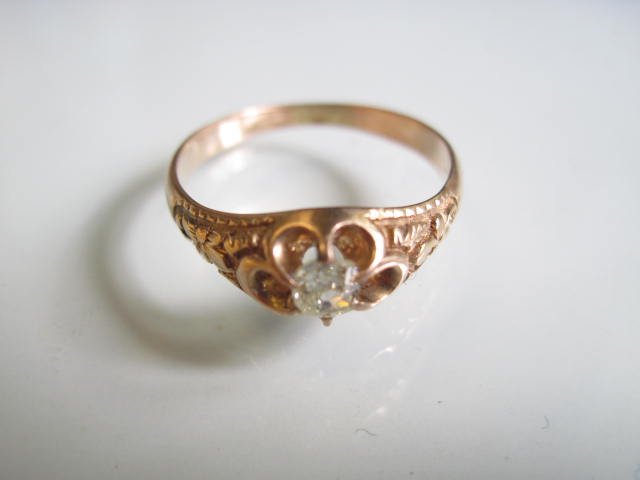 14K Diamond Ring: A 14K(tested) yellow gold antique, floral motif, buttercup style mounting containing a .23 carat old mine cushion cut diamond. Finger size 6-1/2. Weight 2.5 grams.
