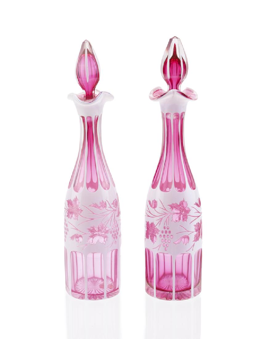 A pair of cranberry overlay cut glass decanters (1 of 2)