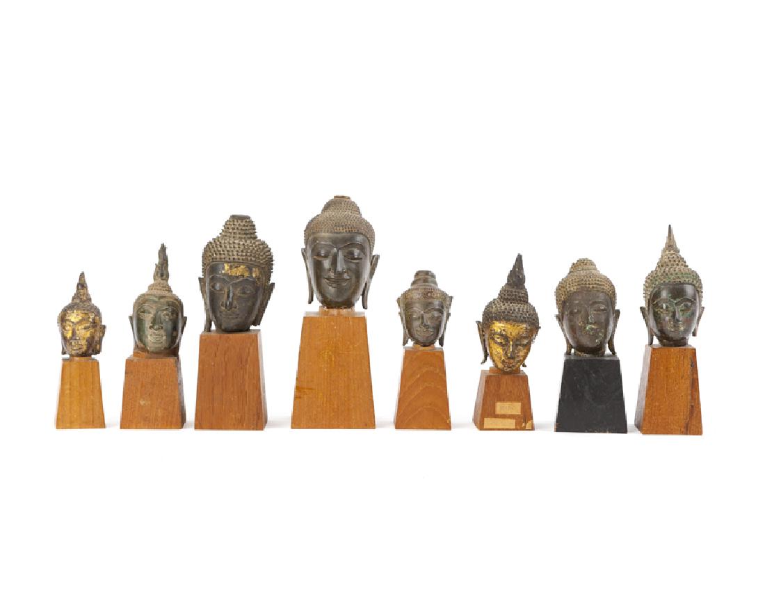 A collection of eight bronze buddha heads (1 of 2)