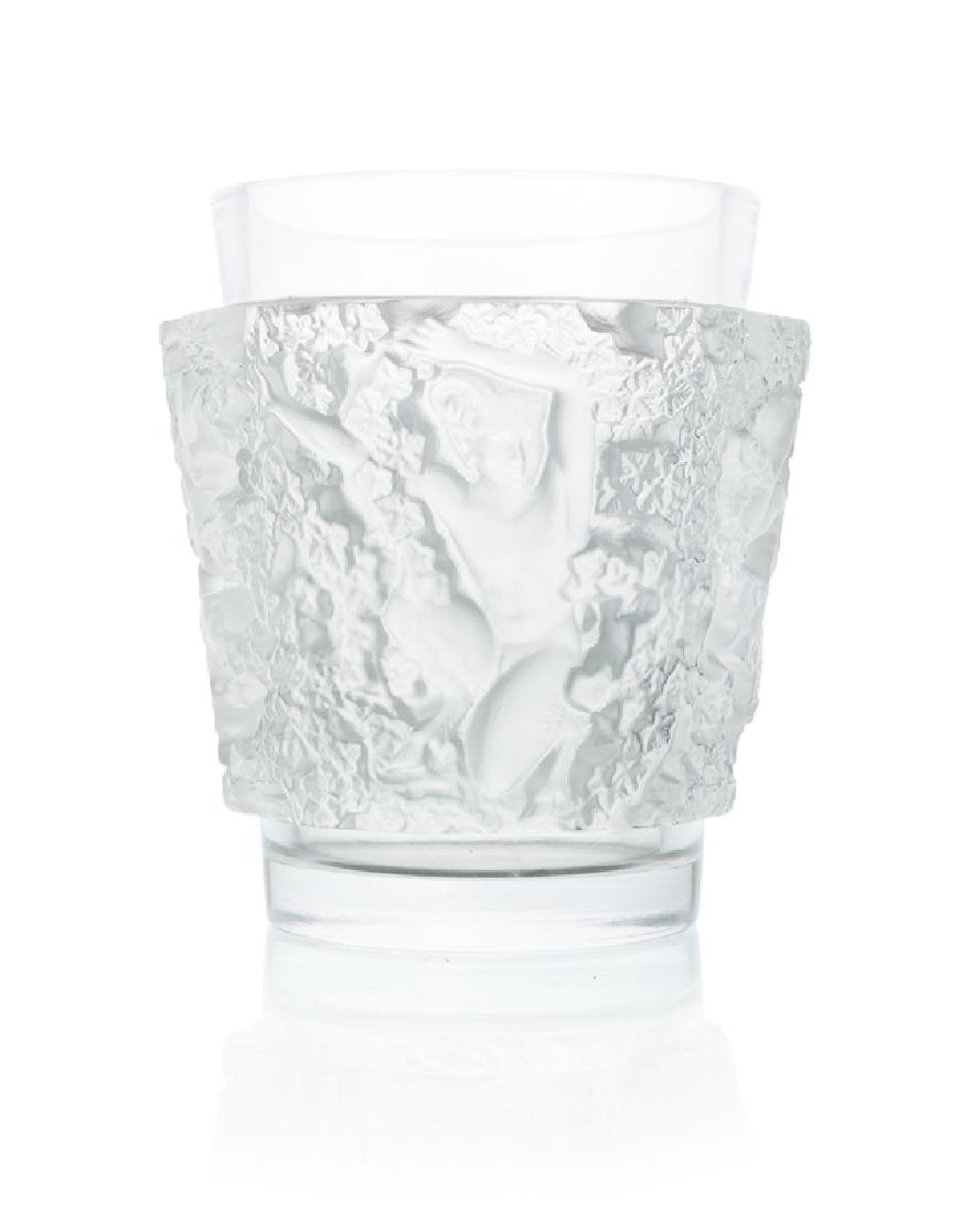 A Lalique art glass ''Bacchus'' vase: Contemporary Etched mark: Lalique France Tapering cylindrical form relief-decorated with crouching fauns in foliage, clear and frosted colorless glass 7" H x 6.25" Dia. Provenance: Private Collection,