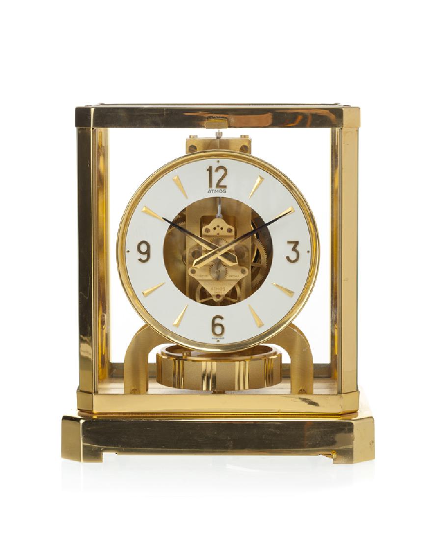 A Jaeger-LeCoultre Atmos clock: 1980s Face marked: Atmos / Fifteen (15) / Jewels / Jaeger-LeCoultre / Atmos / Swiss / Swiss Made Polished brass and glass case 9.25" H x 8.25" W x 6.625" D