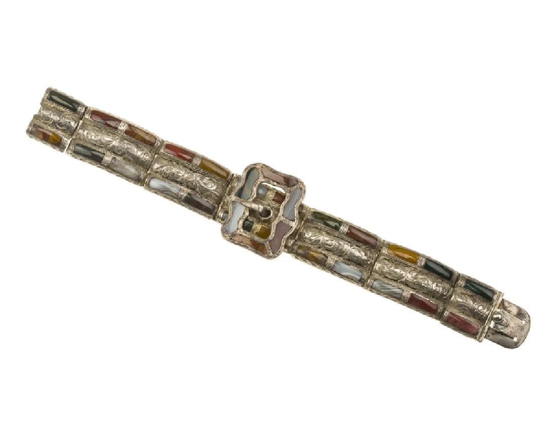 An Antique silver and gem-set ''Scottish pebble'': Circa 1865 The engraved silver panels set with bloodstone, grey agate, and jasper cabochons centering a non-functioning buckle pendant 7 1/4" L x 1 1/4" W 49.8 grams Provenance: The Estate of Georgia
