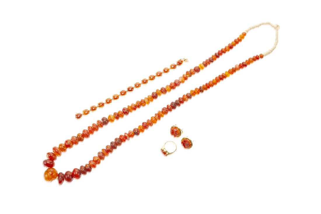 A group of carnelian jewelry, including GUMPS: 18K and 14K yellow gold Including an 18K yellow gold ring (stamped GUMPS), a 14K yellow gold bracelet (stamped GUMPS), a pair of 14K yellow gold earrings, and a bead necklace with squaw-wrapped neck 1