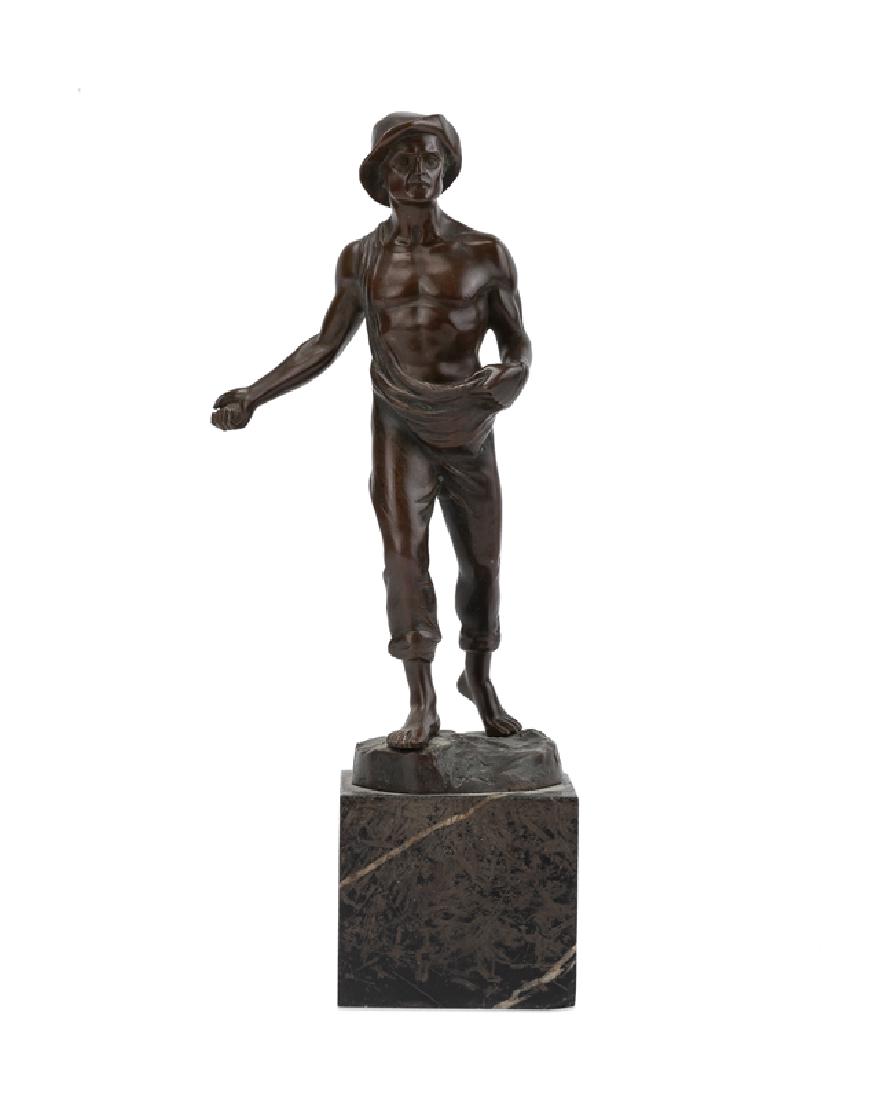 A bronze sculpture of a man sowing seeds (1 of 3)