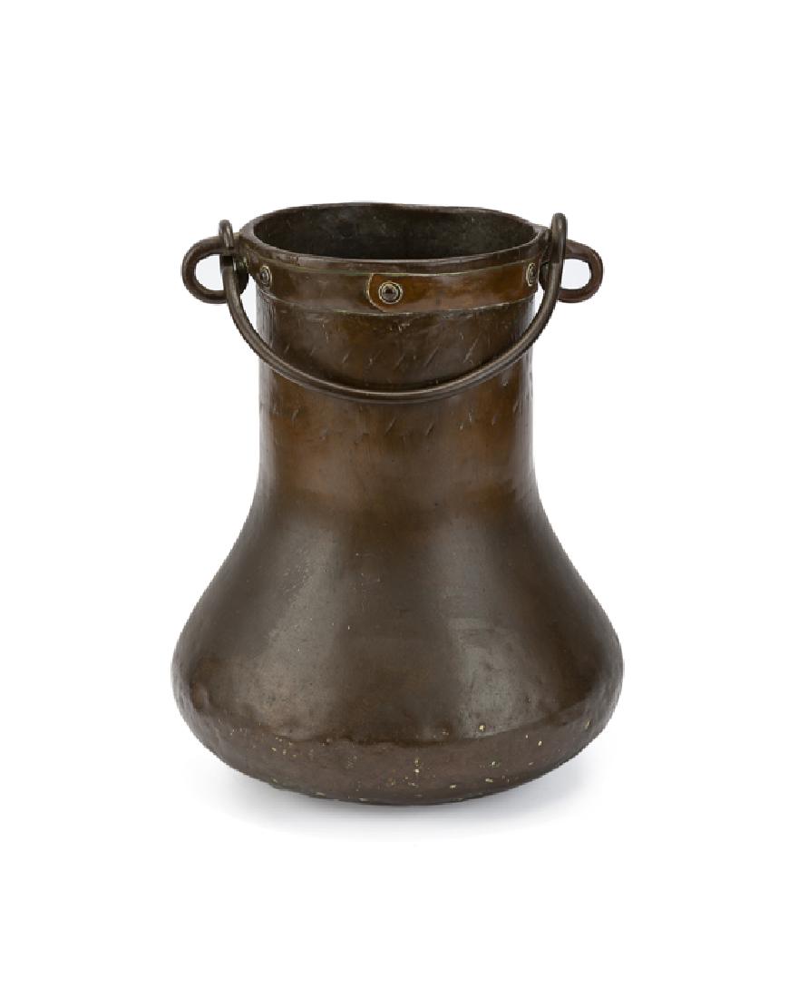 A copper bail-handled umbrella stand: First quarter 20th century Apparently unsigned In the manner of L & J.G. Stickley, cylindrical neck widening to a bulbous base 15" H x 12" Dia. (19.25" H with handle extended) Provenance: The Estate o