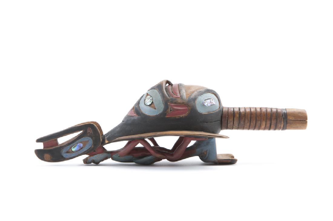 Rich Lavalle (20th century Sitka, AK): A Tlingit-style rattle with raven, shaman and frog Polychrome-painted wood with mother-of-pearl inlay Inscribed signature to end of handle: Lavalle 4.125" H x 13" W x 4.5" D Provenance: Estate, Los An