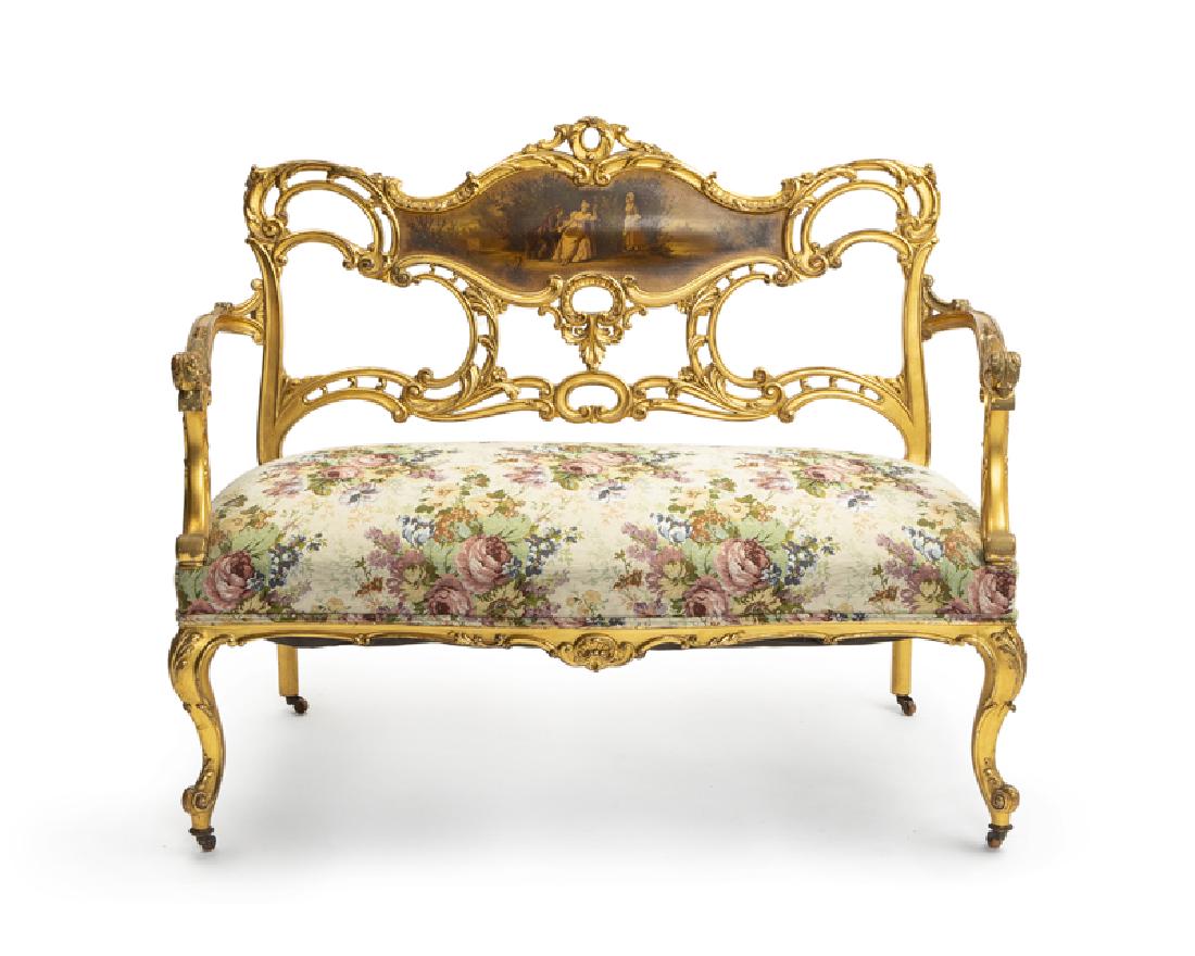 A Louis XV and Vernis Martin-style giltwood settee: Early 20th century Apparently unsigned The pierced scrolled foliate and floral-carved back centered by a Vernis Martin panel painted with figures in a garden, over an upholstered seat, raised on cabri