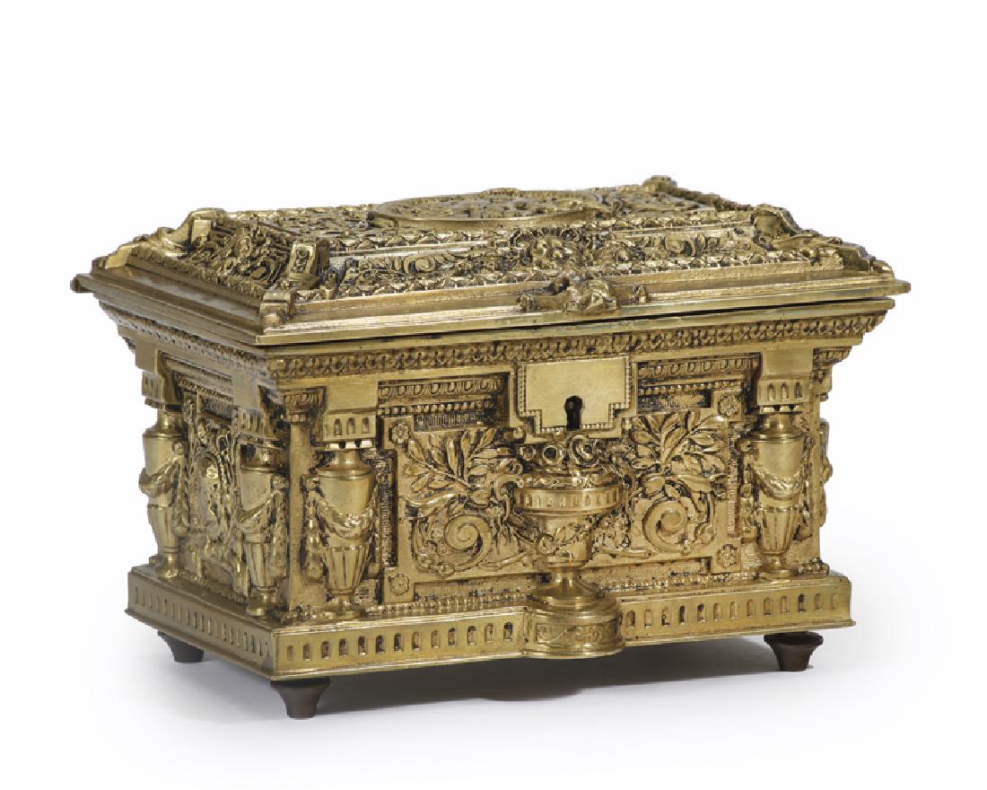 A French Napoleon III gilt-bronze jewelry casket: Fourth quarter 19th century All-over decorated in high relief with cherubs, floral sprays, and urns opening to reveal a two-level velvet and satin-lined interior 4.25" H x 6.5" W x 4.5" D