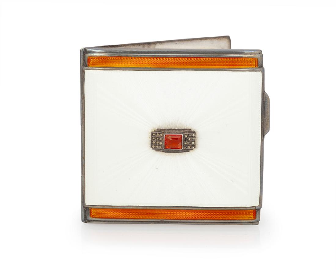 An English silver and enamel compact: 1937 Stamped for The Goldsmiths and Silversmiths Co. Ltd. Of white and orange guilloche enamel set with an orange stone and marcasites 3" H x 2.875" W 3.500 oz. troy approximately Provenance: The Esta