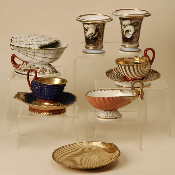 A GROUP OF FRENCH SHELL-FORM TABLE ACCESSORIES: comprising two cachepots, an inkstand and underplate, a cup and saucer, a sauceboat with integral cover, a dish and a further sauceboat; the tallest: 4.75'', 9 pcs