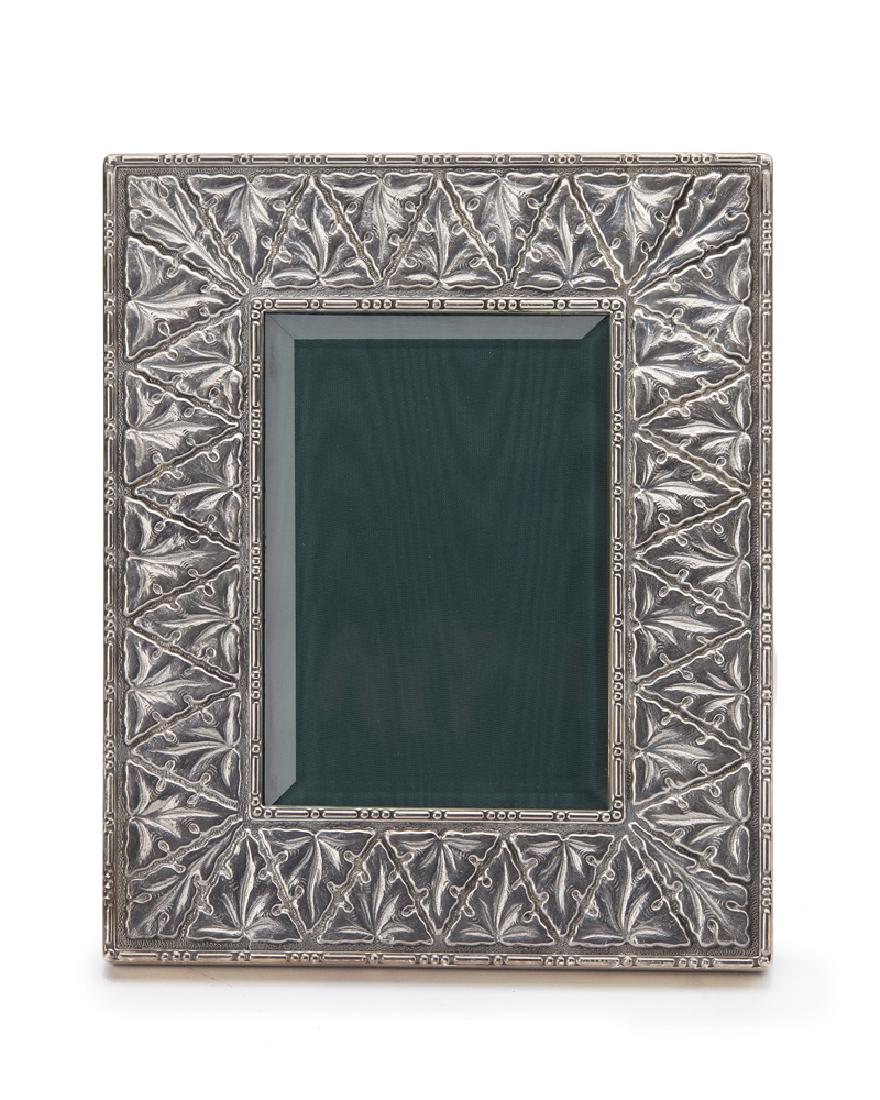 A Buccallati sterling silver picture frame: Stamped: 925 Gianmario Buccellati The embossed silver frame with beveled glass to accommodate a 3.25" x 4.75" photograph 7.75" H x 6.375" W x .75" D
