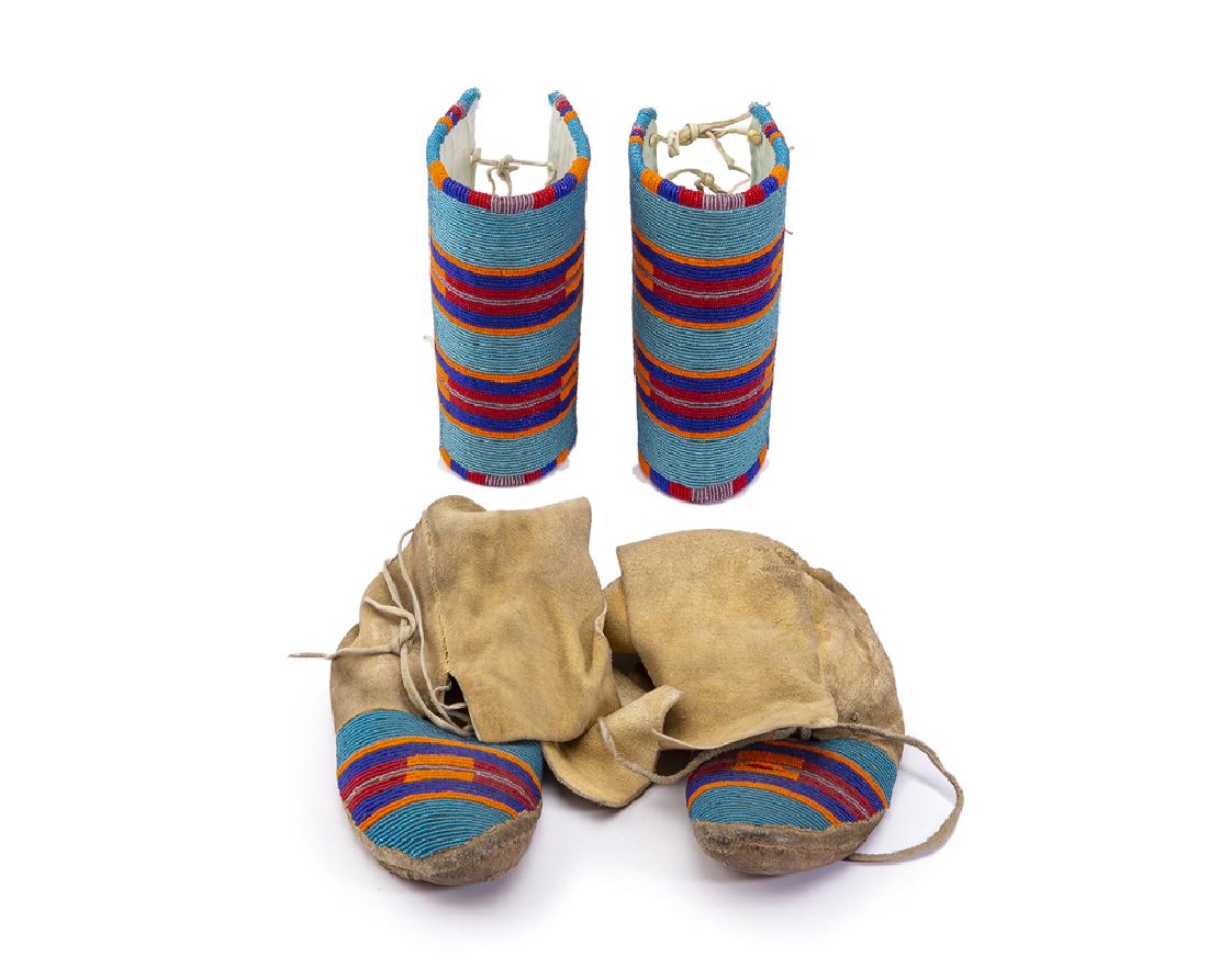 A pair of Crow beaded moccasins and leggings (1 of 3)