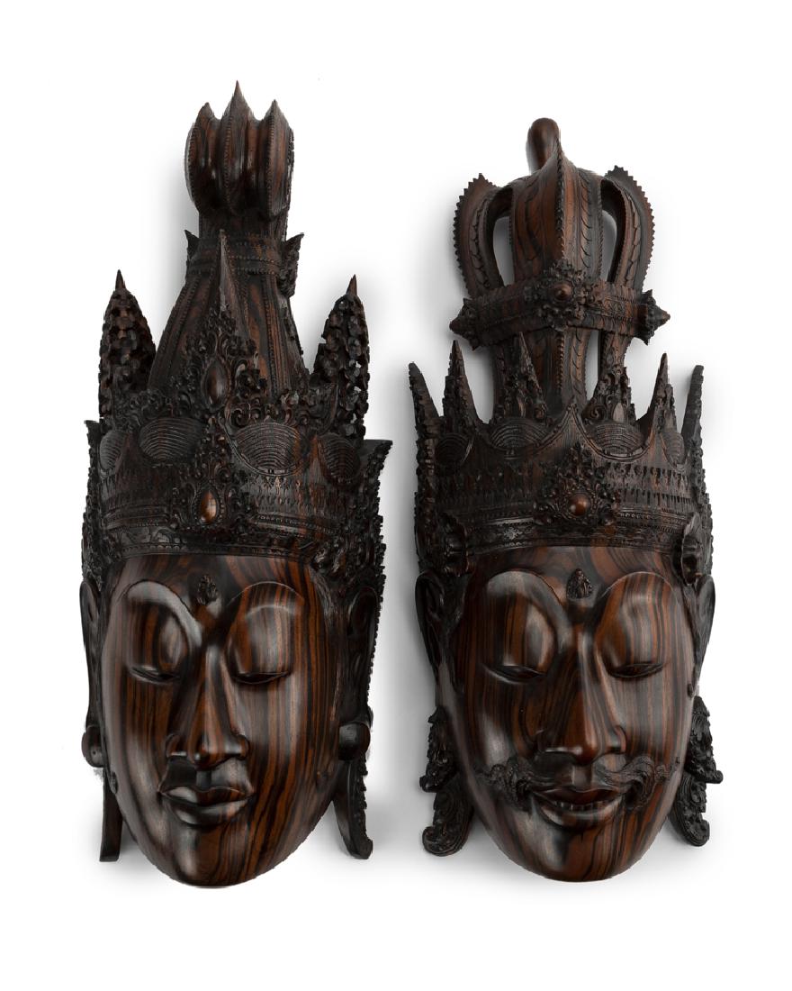A pair of Thai carved masks: Contemporary Comprising a king and queen Larger: 19" H x 7.75" W x 4.25" D