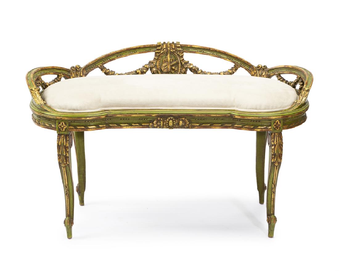 A French carved polychrome and giltwood window bench: 1920s The kidney-shaped seat over a carved giltwood and polychrome painted frame 25" H x 41" W x 19' D