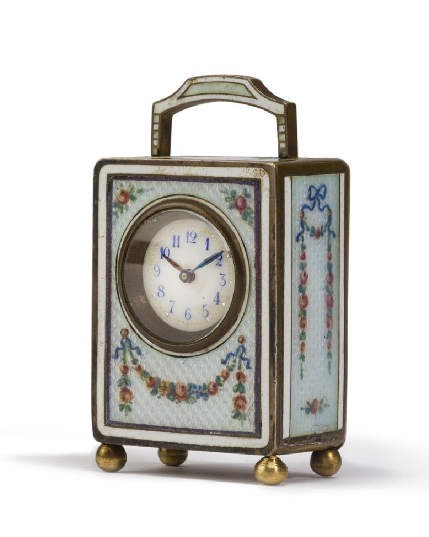 A miniature enameled desk clock: Second quarter 20th century White dial with Arabic hour markers enclosed in a rectangular enameled case 2.75" H x 1.5" W x 1" D
