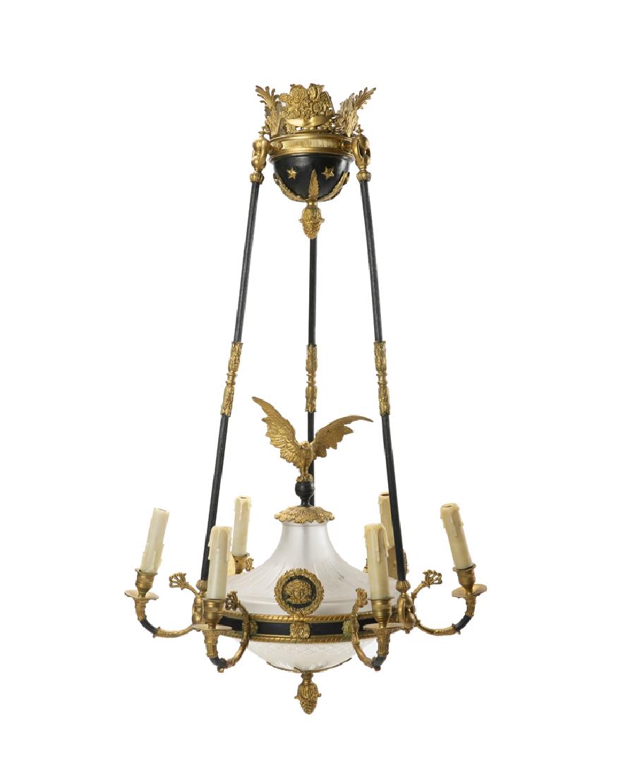 A French Empire-style ceiling fixture: First half 20th century The six-light gilt and patinated bronze chandelier with eagle suspending from a three-arm crown 37.5" H x 22.5" Dia.