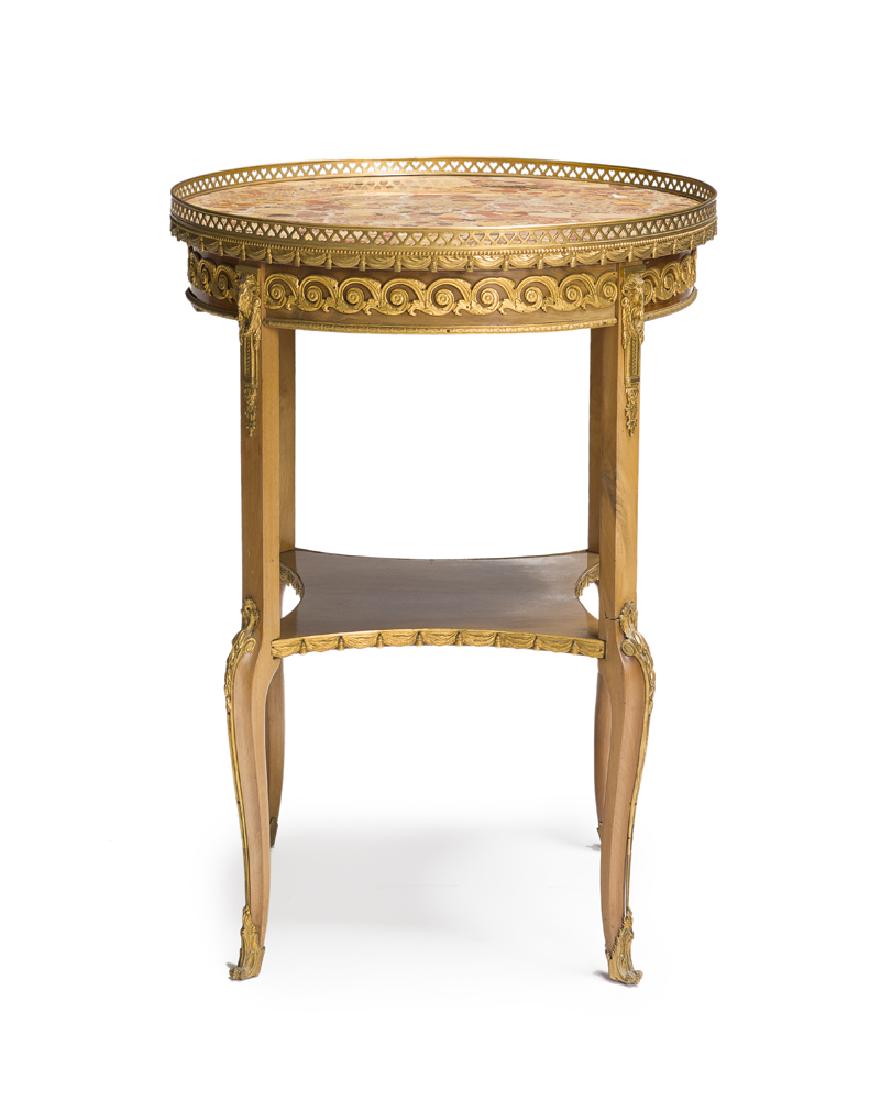 A French Louis XV-style gueridon table: Late 19th/early 20th century Round marble top with reticulated gilt bronze gallery raised on post and cabriole legs joined by a squared undershelf adorned with gilt bronze mounts 30.5" H x 22.25" Dia.