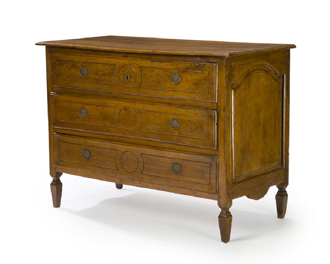 An Italian neo-classical walnut commode: Late 18th/early 19th century Rectangular top over three long drawers fitted with a lock raised on tapered post legs 38" H x 54" W x 25" D