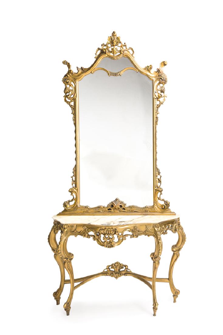 An Italian giltwood console and mirror: 20th century The openwork-framed mirror over a white marble-topped console with carved and openwork apron raised on scrolled legs, 2 pieces 99" H x 50" W x 16.25" D
