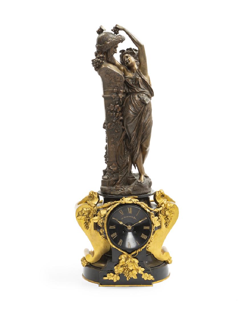 A French gilt and patinated bronze clock: Second half 19th century Bronze signed: A. Carrier for Albert Ernest Carrier Belluse (1824-1887 French); works signed: Barrard & Vignon / Fts D'Horologerie / Rue Commines 7 / Paris / 998; face with pa