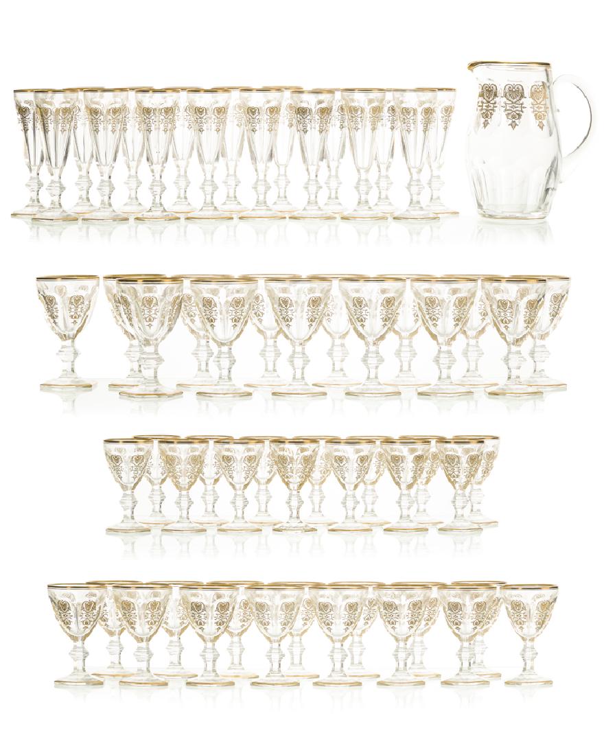 A set of Baccarat ''Empire'' glassware: Second half 20th century Each signed: Baccarat Each gilt-decorated and cut colorless glass comprising seventeen champagne flutes (7" H x 2.5" Dia.), fourteen white wine glasses (4.875" H x 2.75" Dia.)