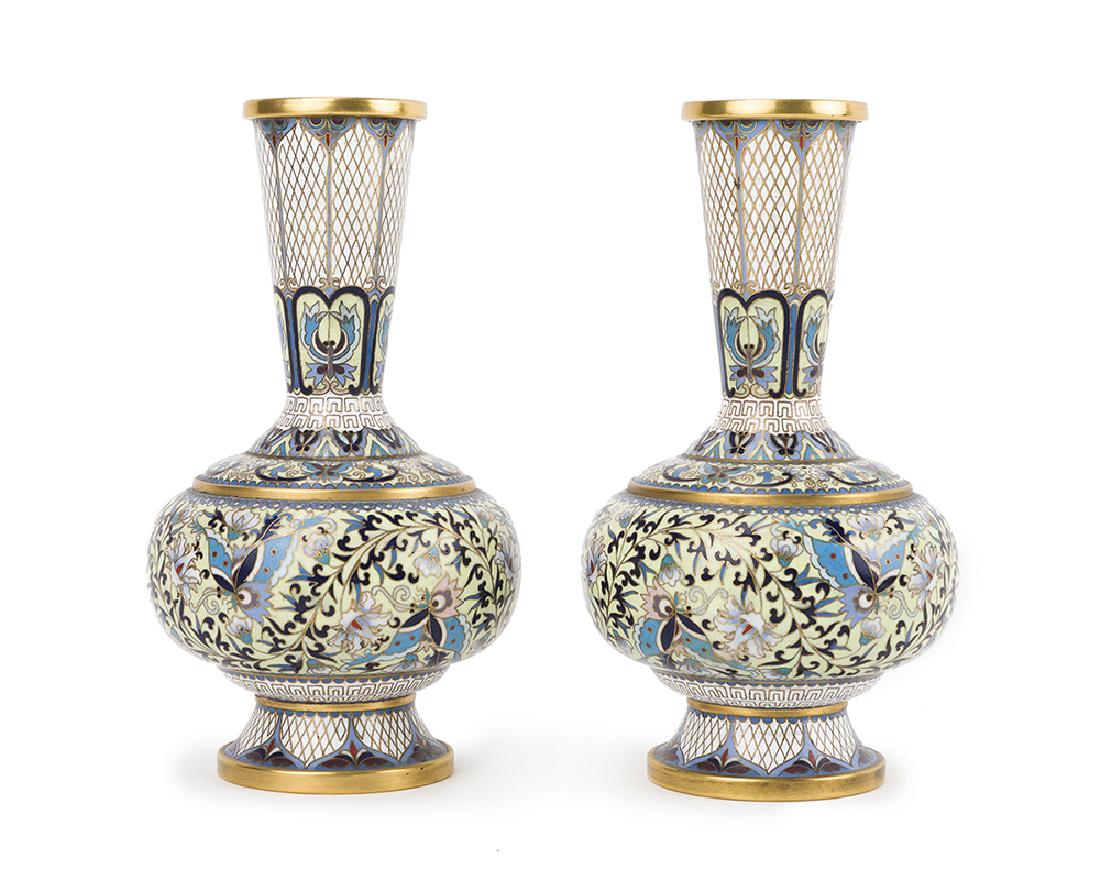 A pair of Chinese cloisonné vases: Second half 20th century The white ground with bands of floral and geometric decoration, 2 pieces Each: 8.125" H x 4.25" Dia.