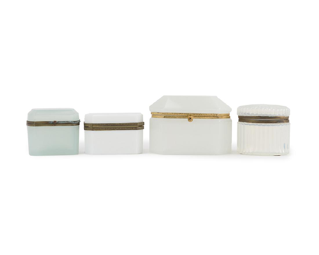 Four white opaline glass vanity boxes: 20th century Each rectangular box with canted corners set with gilt metal mounts, 4 pieces Largest: 5.25" H x 7" W x 4" D