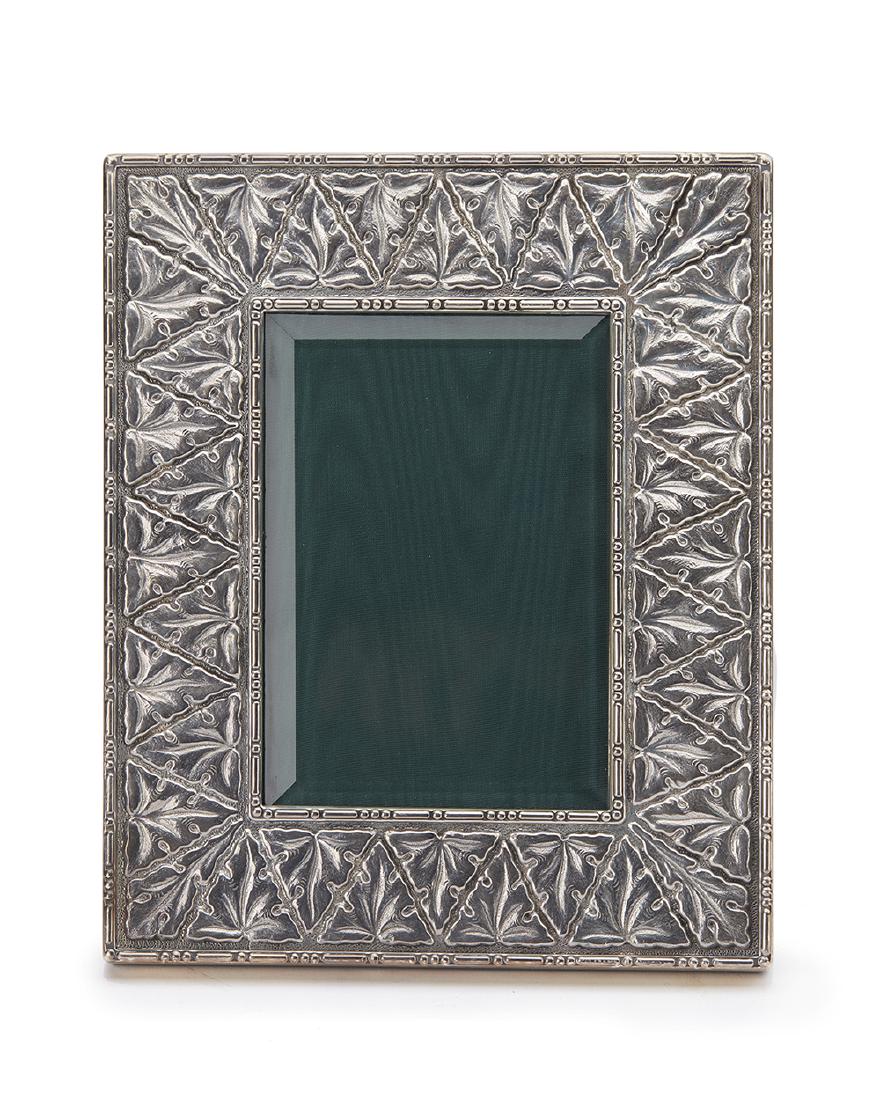 A Buccallati sterling silver picture frame: Stamped: 925 Gianmario Buccellati The embossed silver frame with beveled glass to accommodate a 3.25" x 4.75" photograph 7.75" H x 6.375" W x .75" D