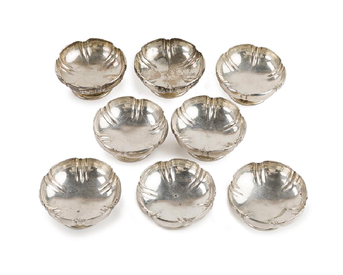 Eight sterling silver salt cellars/nut dishes: First half 20th century Each stamped: Sterling; Further stamped: TOF [in oval] Each fluted bowl raised on a widening pedestal base, 8 pieces Each: 1.125" H x 2.5" Dia. 13.105 oz. troy approximately