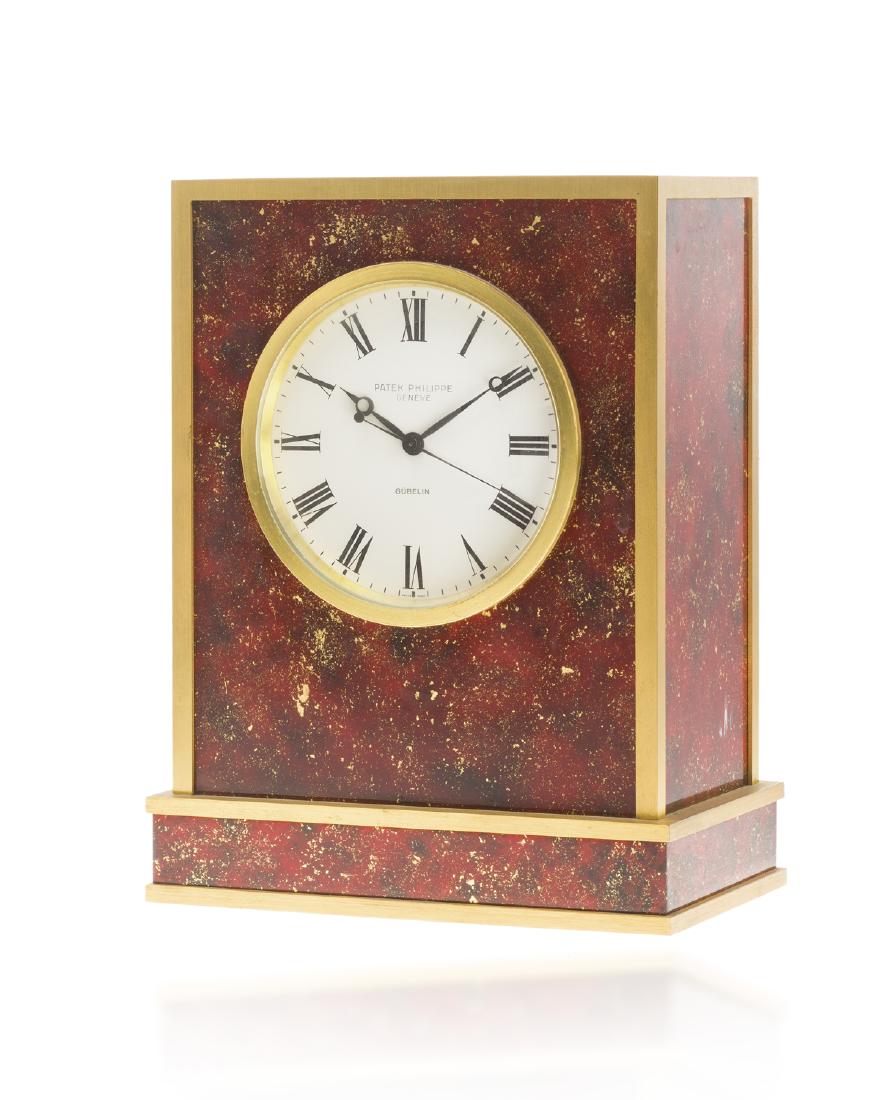 A Patek Philippe electronic table clock: Circa 1970 No: 1.800.070 Dial: Circular white dial, Black Roman numberal hour markers, black outer minute/seconds track, black Breguet hands, center seconds, signed Patek / Philippe / Geneve / Gubel