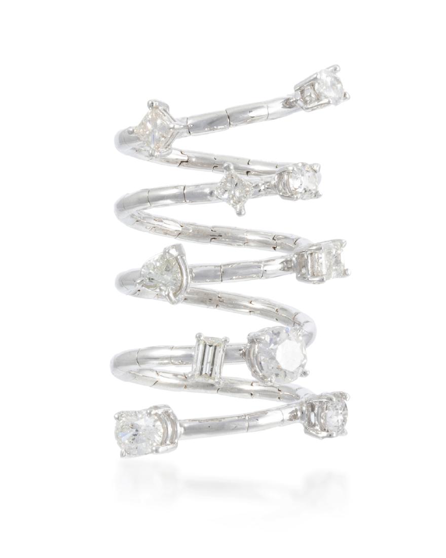 A diamond spiral ring: 18k white gold Set with ten variously-cut diamonds including heart, emerald, round, oval, and princess totaling 3.16 cts. and graded G-I color, VS-I clarity in a flexible spiral setting Ring size: 6 1