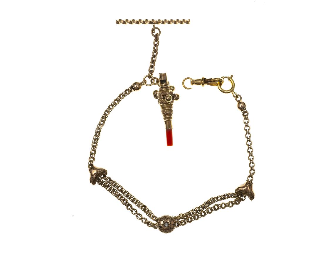 A Victorian coral rattle/whistle charm bracelet: 14k yellow gold A bracelet set with two round diamonds converted from a fob chain, suspending a childs coral teething rattle/whistle 8 3/4" 14. 2 grams