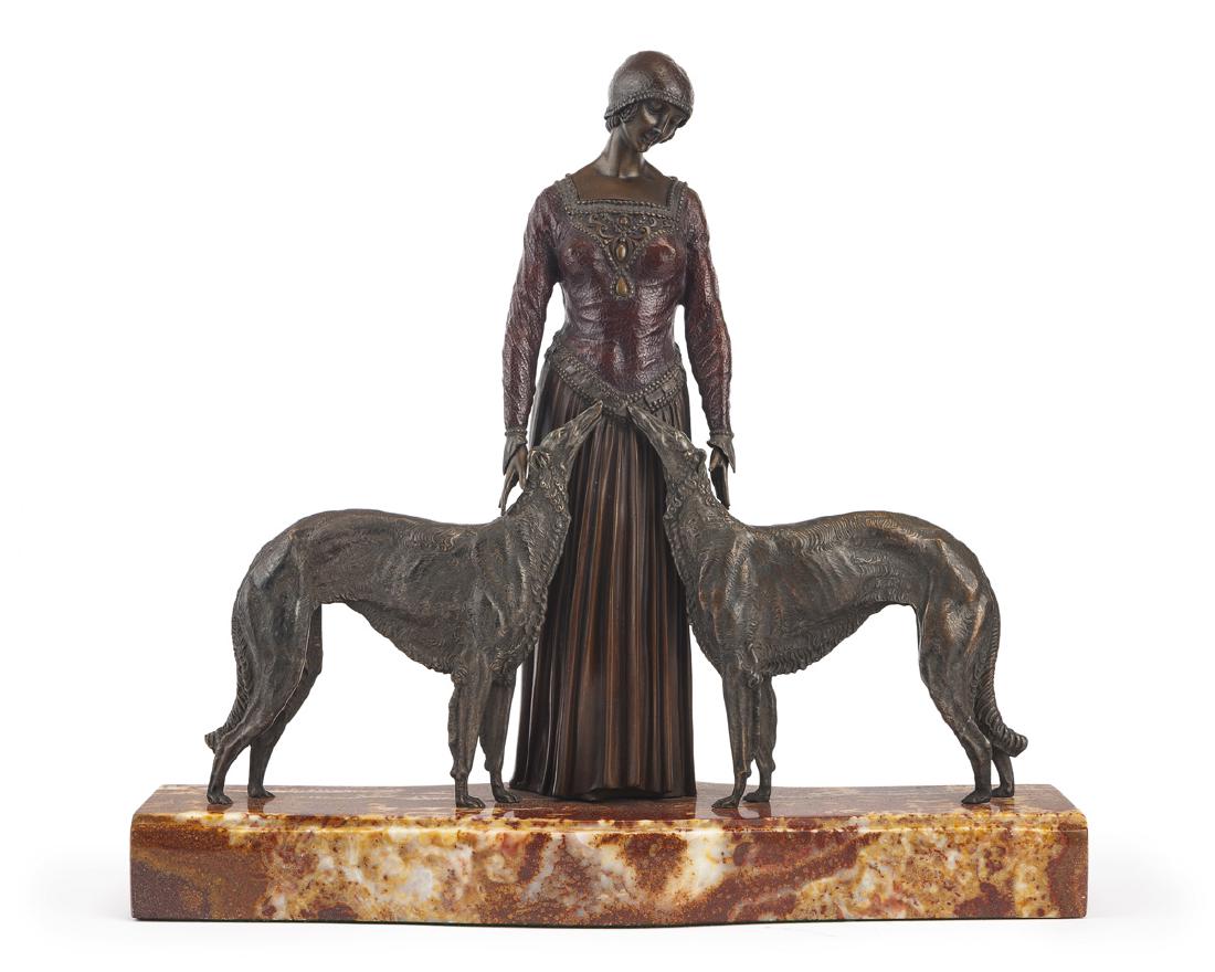 After Demetre Chiparus (1886 - 1947 Romanian): Les Amis Toujours [friends forever], standing woman with two borzois Cold-painted bronze on red marble plinth Etched to base: D.H. Chiparus 22.875" H x 24.75" W x 7.5" D