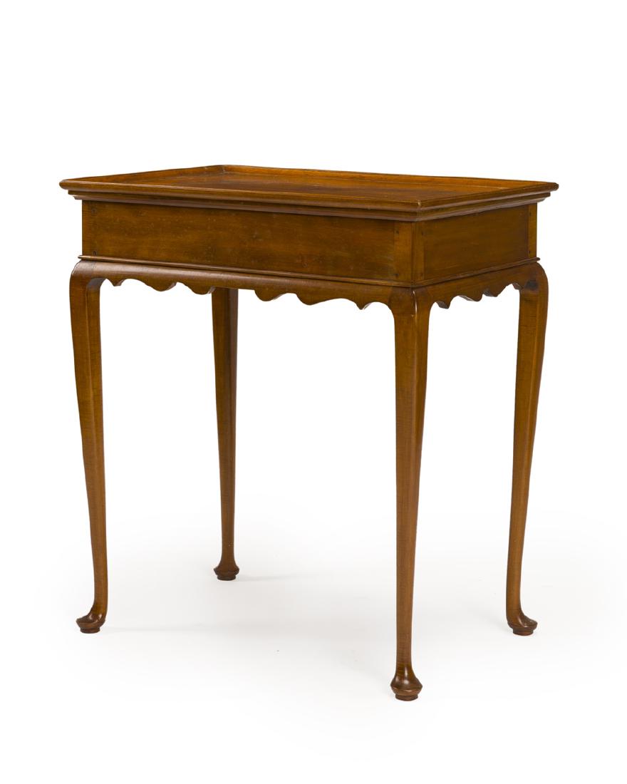 An American maple Queen Anne-style tea table: Late 19th/early 20th century Rectangular top with upswept trim over cabriole legs 29.75" H x 26.5" W x 18" D