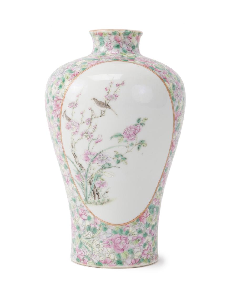 A Chinese Famille Rose vase: Fourth quarter 19th century The white porcelain ground with painted floral design 8.5" H x 4.75" Dia.
