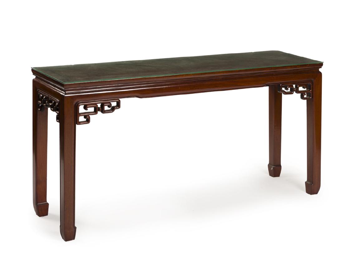A Chinese carved rectangular sofa table: 20th century Rectangular top over carved post legs fitted with a later-added glass top 27" H x 54" W x 15.25" D