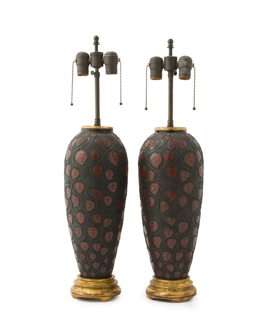 A pair of champleve bronze Art Deco-style lamps: 20th century Each two-light lamp over a vase-form standard, 2 pieces Each (with shade): 27.5" H x 17.5" Dia.