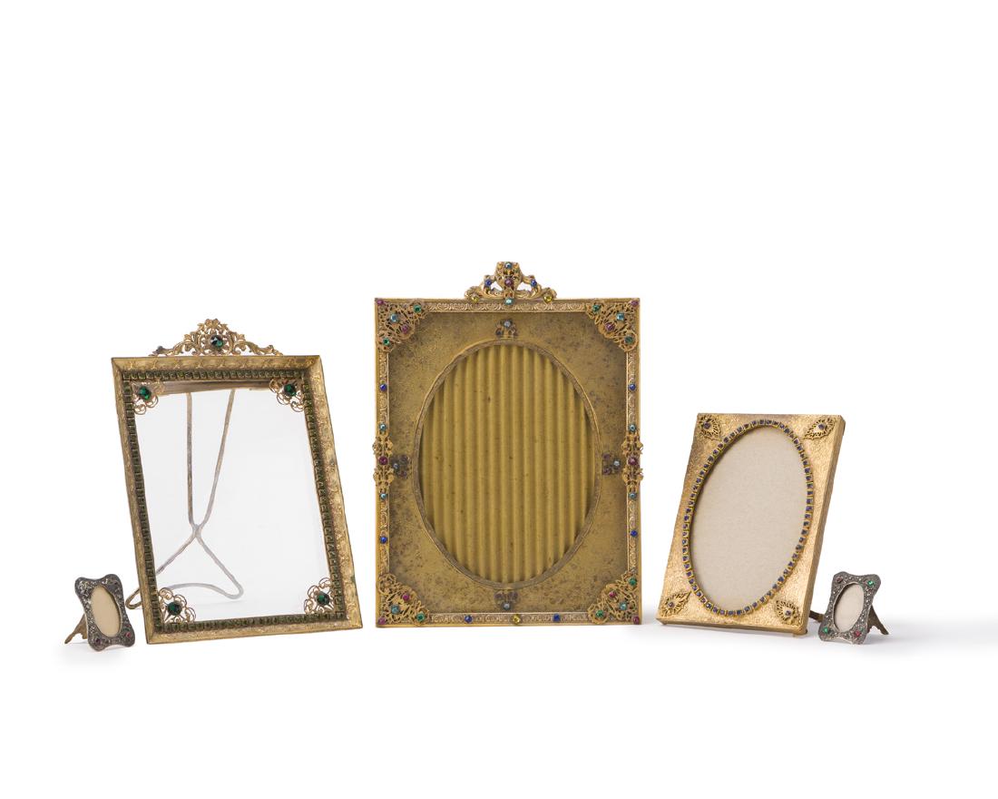 Five jeweled picture frames: 20th century Each set with glass jewels in a gilt or silvered metal frame Largest: 12" H x 8.325" W