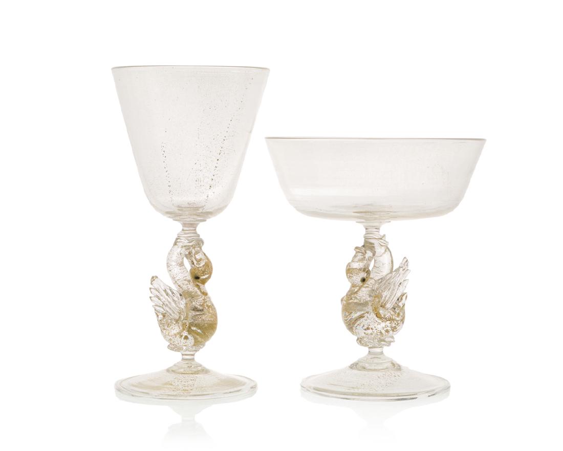 A group of Salviati swan-motif glassware: Third quarter 20th century Comprising ten champagne/sherbet glasses (5.5") and seven red wine glasses (7") in clear and gold with swan-form stems, 17 pieces
