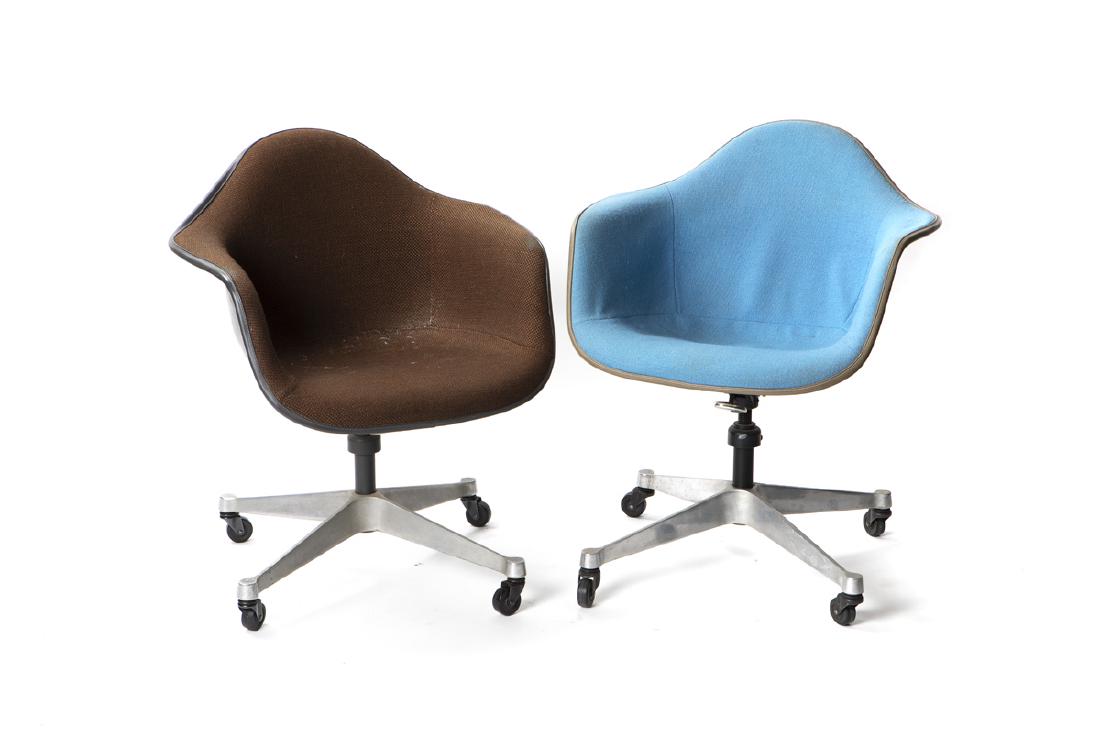 Two Eames for Herman Miller "PACC" molded shell: 1974-1978 Each with Herman Miller fabric tag to seat, dated 1974 and 1978 Designed 1950 by Charles and Ray Eames (1907-1978 and 1912-1988 Los Angeles, CA), each molded armchair, one black and one whit