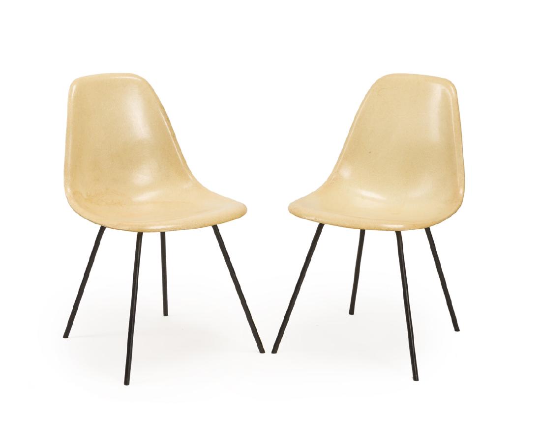 Two Eames fiberglass shell chairs: Third quarter 20th century Designed 1950 by Charles and Ray Eames (1907-1978 and 1912-1988 Los Angeles, CA) each fiberglass seat on metal post legs, 2 pieces Each: 31.25" H x 18.25" W x 21" D