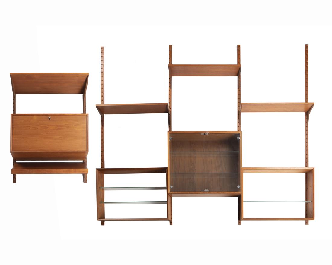 A Danish Modern teak modular wall shelf: Third quarter 20th century Possibly designed by Arne Hovmand-Olsen (1919-1989 Danish), the four-section unit designed with an arrangement of shelves, cabinets, and a secretary desk Fully assembled: 79