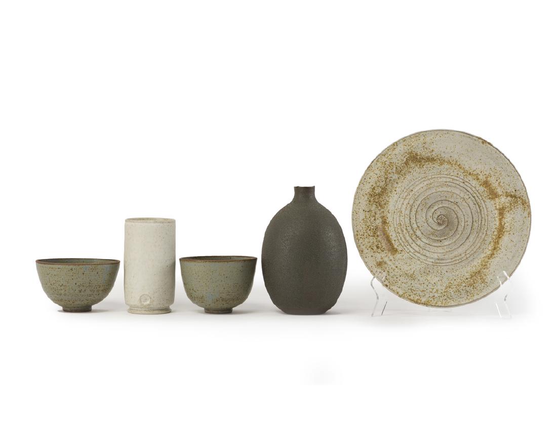Five modern glazed ceramic objects: Comprising a matte white vase, signed: Wadham, a pebbled tall vase indistinctly signed, a matte white speckled glazed charger, signed: Wadham, and two matching blue bowls, initialed: SMG, 5 pieces Lar