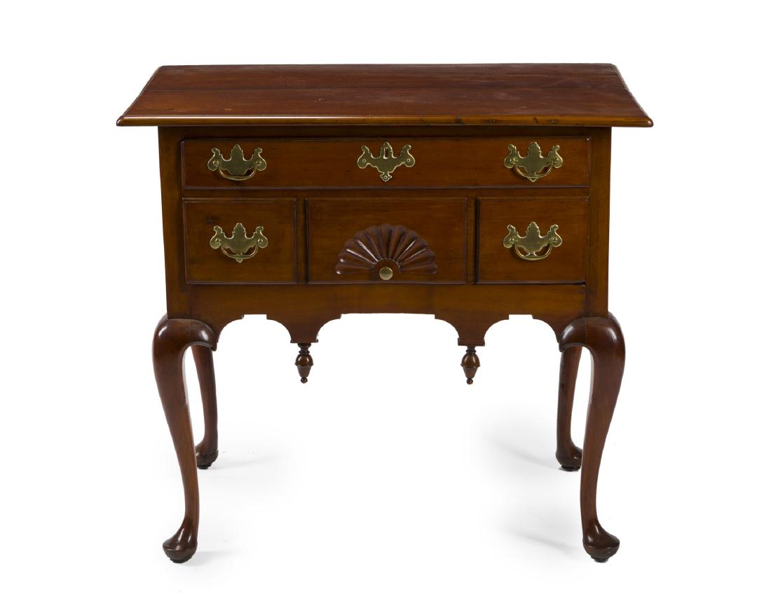 An American lowboy chest: 19th century The rectangular top over a single faux-front drawer raised on cabriole legs 31" H x 34" W x 21.5" D